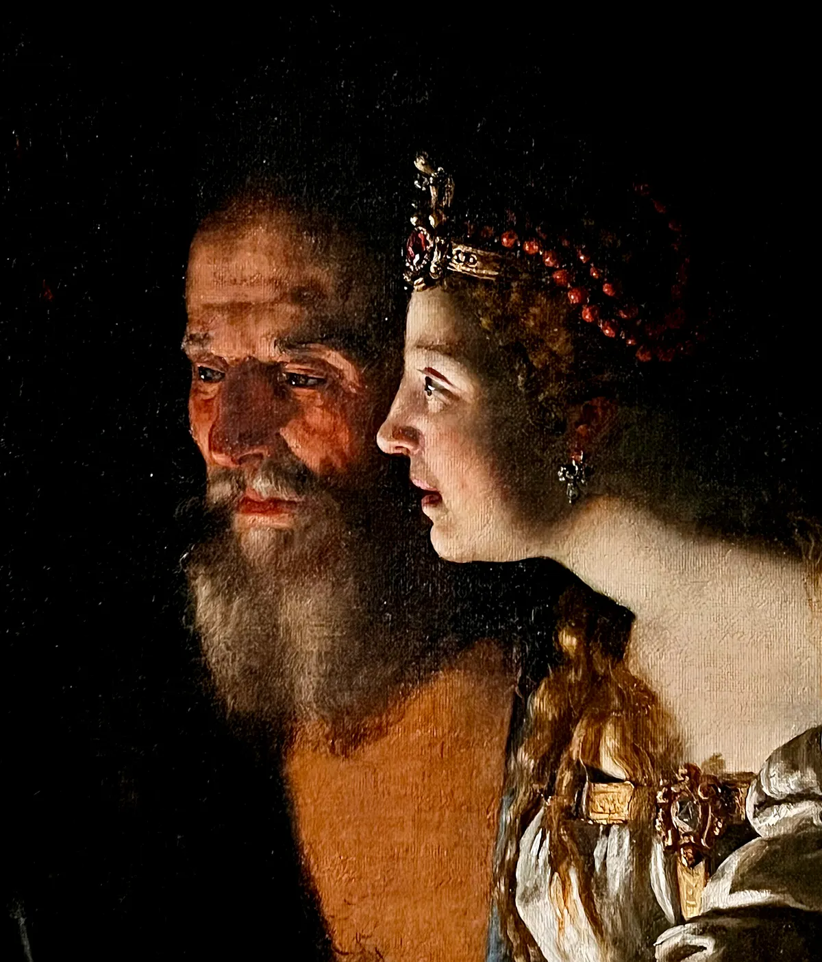 Candlelit detail of an old man and a young woman, from a painting in the Borghese collection